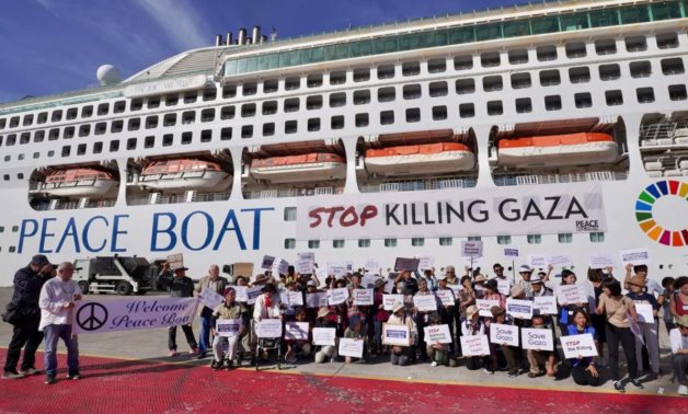 Japanese Peace Boat hoisting pro-Gaza banners 