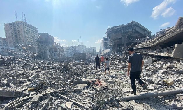  Palestinians inspect the damage following an Israeli airstrike on the El-Remal aera in Gaza City on October 9, 2023 - WAFA