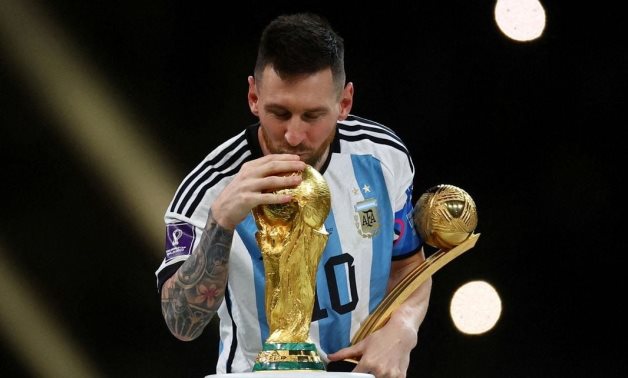 Argentina's Lionel Messi kisses the World Cup trophy after receiving the Golden Ball award as he celebrates after winning the World Cup REUTERS/Kai Pfaffenbach/File Photo 