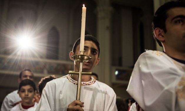 File- Egyptian Coptic Catholic altar boys attend the Christmas Eve mass at a church in Nasr City of Cairo, Egypt, on Dec. 24, 2014- CC via Flickr/ Chaoyue 超越 PAN 潘