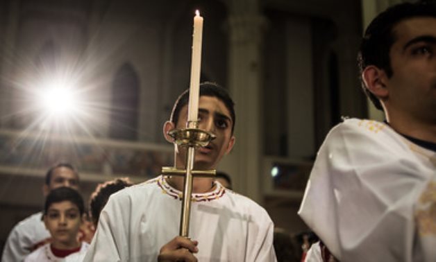 File - Egyptian Coptic Catholic altar boys attend the Christmas Eve mass at a church in Nasr City of Cairo, Egypt, on Dec. 24, 2014- CC via Flickr/ Chaoyue PAN 