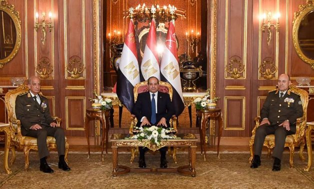 Egypt's President Abdel Fattah El Sisi meets with Minister of Defense Mohamed Zaki (L) and Chief of Staff of the Armed Forces Osama Askar (R) on the sidelines of the Armed Forces' Sohour banquet