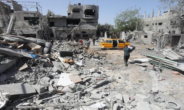 Citizens inspect the effects of destruction after occupation aircraft bombed a number of homes in Al-Maghazi Camp - Gaza