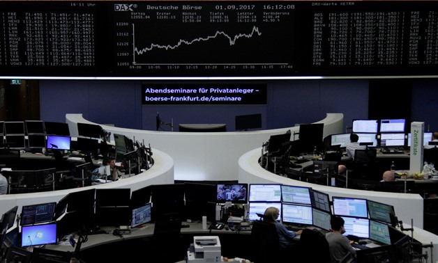 Traders work in front of the German share price index, DAX board, at the stock exchange in Frankfurt, Germany, September 1, 2017. REUTERS/Staff/Remote