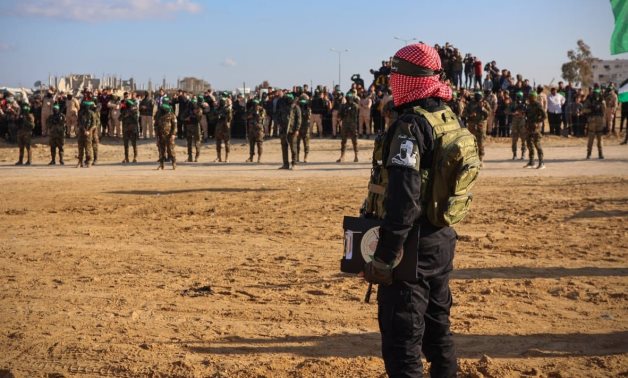 Hamas fighters line up in a ceremony to hand over freed Israeli captives to the Red Cross in Gaza – FILE/Hamas
