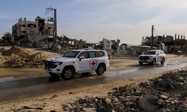 Vehicles of the International Committee of the Red Cross (ICRC) drive through the devastation in Gaza caused by the Israeli war. ICRC