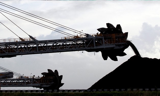 A stacker/reclaimer places coal in stockpiles at the coal port in Newcastle,Australia, June 6, 2012. REUTERS/Daniel Munoz/File photo

