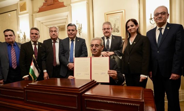 The Palestinian technocratic committee for Gaza signs the mandate statement after an inaugural meeting in Cairo