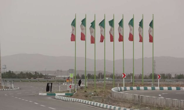 The Iranian national flag flies over the city of Qom, Iran. Photo by Mustafa Meraji/picryl
