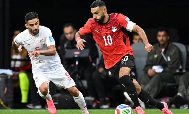 Iran's Milad Mohammadi in action with Egypt's Mohamed Salah REUTERS/Troy Wayrynen