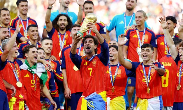 Spain's Ferran Torres lifts the trophy with teammates after winning the World Cup REUTERS/Kai Pfaffenbach
