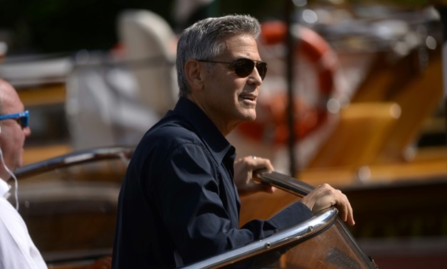 George Clooney arrives on a taxi-boat at the Excelsior Hotel during the 74th Venice Film Festival