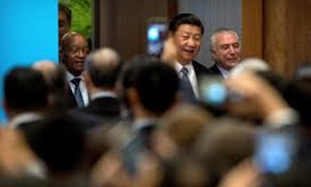 (L-R) South African President Jacob Zuma, Chinese President Xi Jinping, and Brazilian President Michel Temer arrive for the opening ceremony of the BRICS Business Forum at the Xiamen International Conference and Exhibition Center in Xiamen, China Septembe
