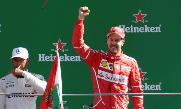 Formula One - F1 - Italian Grand Prix 2017 - Monza, Italy - September 3, 2017 Ferrari's Sebastian Vettel celebrates on the podium alongside Mercedes' Lewis Hamilton REUTERS/Max Rossi