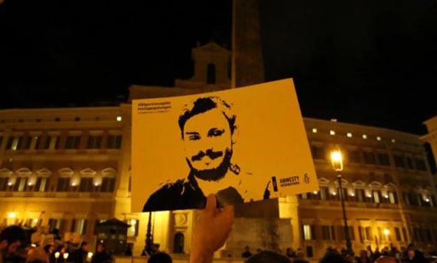 FILE PHOTO: A man holds a placard during a vigil to commemorate Giulio Regeni, who was found murdered in Cairo a year ago, in... Alessandro Bianchi August 14, 2017 02:46pm EDT