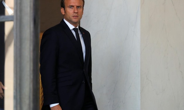 FILE PHOTO: French President Emmanuel Macron accompanies guests after a meeting at the Elysee Palace in Paris, France, August 31, 2017. REUTERS/Philippe Wojazer