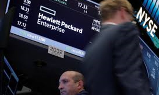 FILE PHOTO - A trader passes by the post where Hewlett Packard Enterprise Co., is traded on the floor of the New York Stock Exchange (NYSE) in New York City, U.S., May 25, 2016. REUTERS/Brendan McDermid