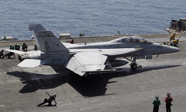 A F/A-18E/F Super Hornets of Strike Fighter Attack Squadron 211 (VFA-211) is lined up for take off on the flight deck of the USS Theodore Roosevelt (CVN-71) aircraft carrier in the Gulf June 18, 2015. REUTERS