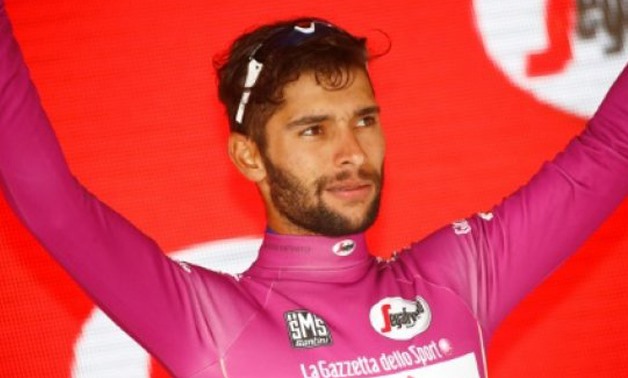 AFP/File | Colombia's Fernando Gaviria of team Quick-Step celebrates the Cyclamen jersey on the podium after the 17th stage of the 100th Giro d'Italia, Tour of Italy, cycling race from Tirano to Canazei on May 24, 2017