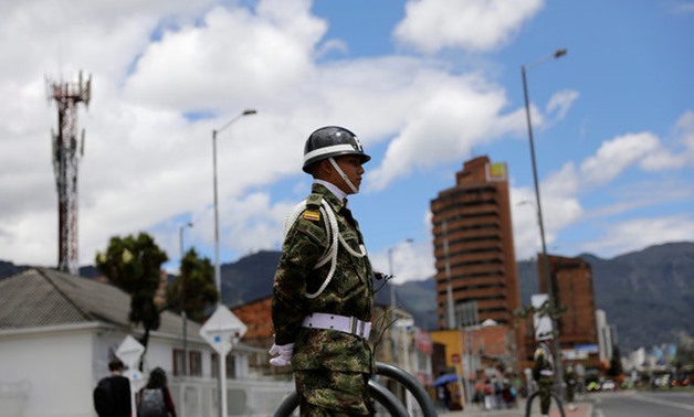 Military police stand guard at a street where Pope Francis will drive past upon his arrival in Bogota - REUTERS