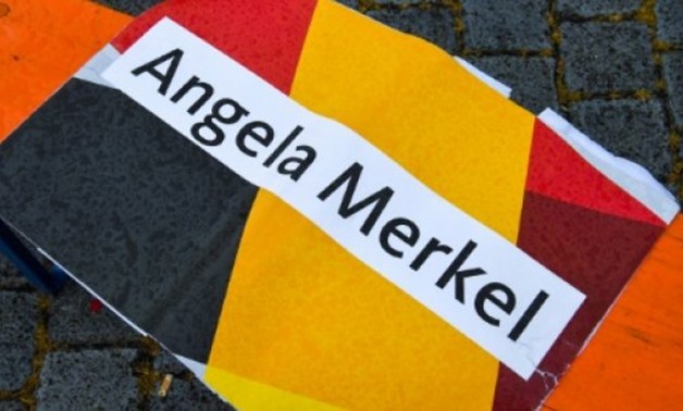 © AFP | A discarded placard after a rally by German Chancellor Angela Merkel on Wednesday in the Saxony city of Torgau, where police said two protesters made the Nazi salute
