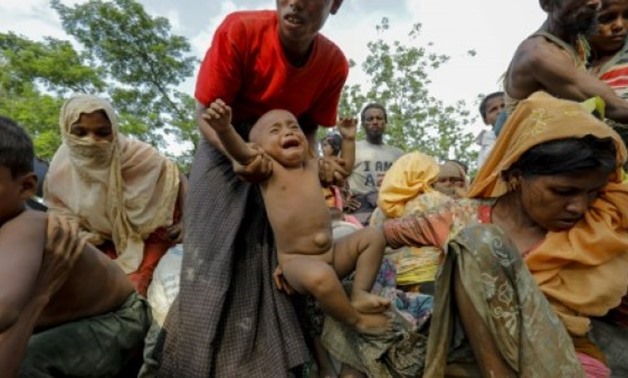 Rohingya refugees arrive at a makeshift new camp in Unchiprang in Bangladesh - AFP