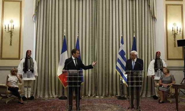 Greek President Prokopis Pavlopoulos and his French counterpart Emmanuel Macron make a joint statement at the Presidential Palace in Athens - REUTERS