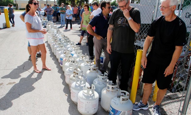 Residents wait in line to purchase propane gas at Lee's Barbecue Center in Boca Raton, Florida, as they continue to prepare for Hurricane Irma's expected arrival. REUTERS/Joe Skipper