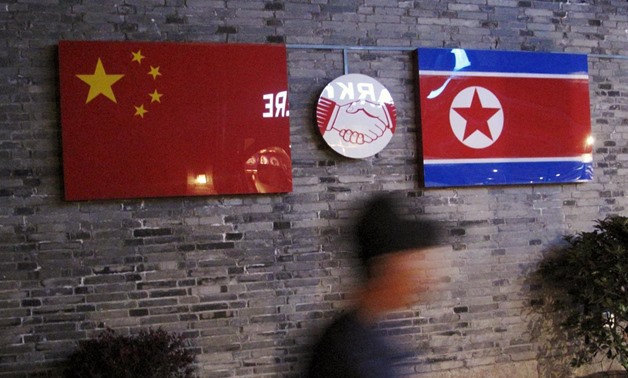 Flags of China and North Korea are seen outside the closed Ryugyong Korean Restaurant in Ningbo, Zhejiang province, China, in this April 12, 2016 file photo. REUTERS
