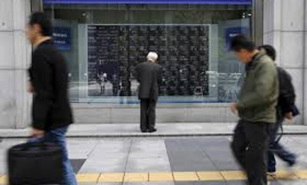 A man looks at a stock quotation board outside a brokerage in Tokyo, Japan, April 18, 2016. REUTERS/Toru Hanai