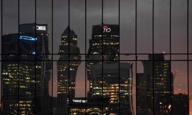 The Canary Wharf business district is seen reflected in windows at dusk in London, Britain December 11, 2016. REUTERS/Toby Melville