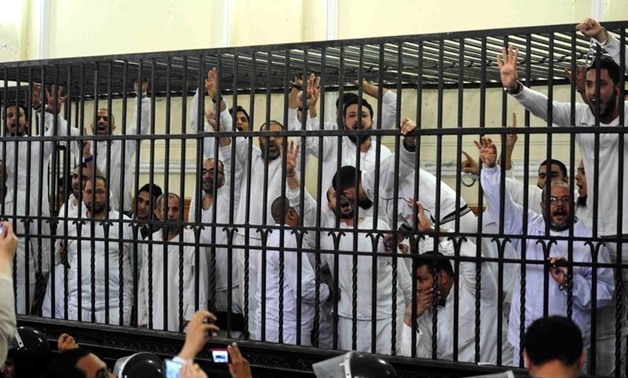 Supporters of former Egyptian president Mohamed Mursi, standing trial on charges of violence that broke out in Alexandria last year in a court in Alexandria, March 29, 2014. REUTERS/Youm7 Newspaper