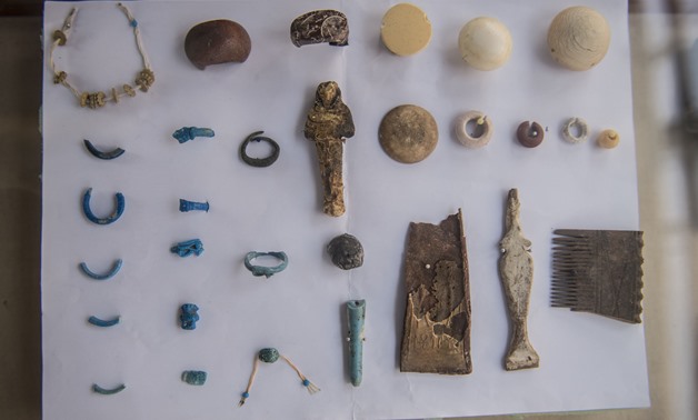 ornaments recovered at the site of a newly-uncovered ancient tomb for a goldsmith dedicated to the ancient Egyptian god Amun, in the Draa Abul Naga necropolis on the west bank of the ancient city of Luxor, which boasts ancient Egyptian temples and burial 