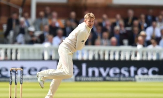England's Joe Root bowls during the third day of the third international Test match against the West Indies at Lord's cricket ground