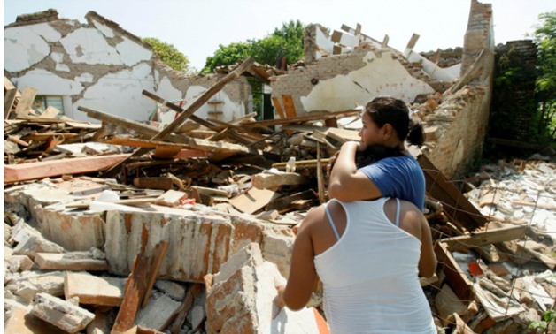 Women hug while standing next to a destroyed house after an earthquake struck the southern coast of Mexico late on Thursday, in Union Hidalgo, Mexico September 9, 2017. REUTERS/Jorge Luis Plata
