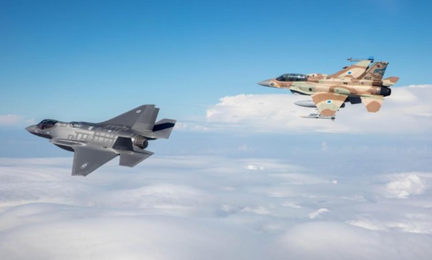 One of Israel's first two F-35 stealth fighter jets flies alongside an F-16 on its maiden flight as part of the Israeli Air Force on December 13 - Press photo
