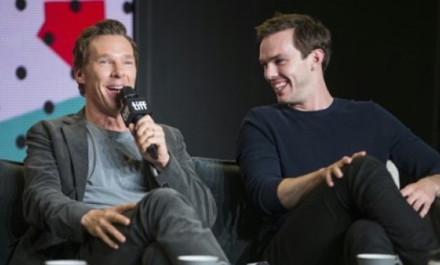 AFP / by Michel COMTE | Nicholas Hoult laughs as Benedict Cumberbatch speaks about "The Current War," in which they star