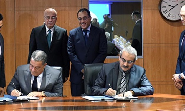 PM Sherif Ismail and Minister of Housing Mostafa Madbouly while witnessing the signing of the agreement- File Photo