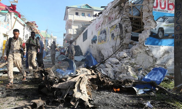 Somali security officers arrive at the scene of a car explosion in Al Mukaram street in Mogadishu - REUTERS