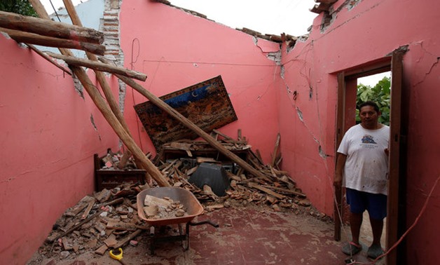 Humberto Cruz stands inside his house destroyed by the earthquake that struck the southern coast of Mexico late on Thursday, in Ixtaltepec - REUTERS
