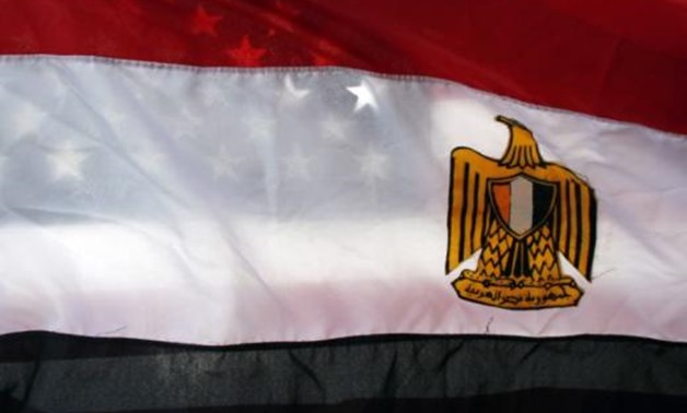 An American flag is seen behind an Egyptian flag - Reuters