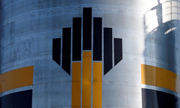 FILE PHOTO - The shadow of a worker is seen next to a logo of Russia's Rosneft oil company at the central processing facility of the Rosneft-owned Priobskoye oil field outside the West Siberian city of Nefteyugansk, Russia, August 4, 2016. REUTERS/Sergei 
