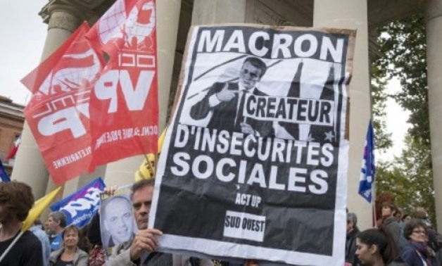 © AFP / by Katy Lee | French President Emmanuel Macron got an early taste of Tuesday's planned demonstrations with a protest against his labour reforms in Toulouse on Monday