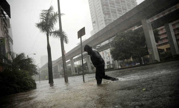  A local resident walks across a flooded street in downtown Miami as Hurricane Irma arrives at south Florida, US September 10, 2017. Carlos Barria, Reuters