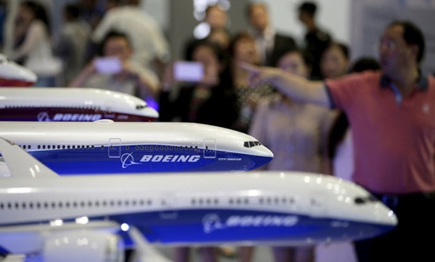 visitors looking at models of Boeing aircrafts at the Aviation Expo China, in Beijing - REUTERS