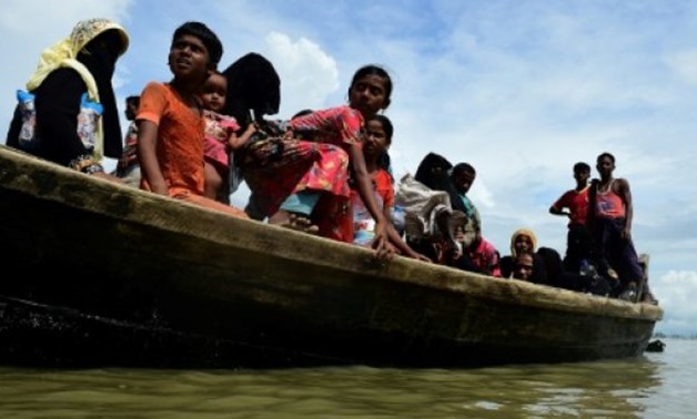 © AFP | Rohingya Muslim refugees disembark from a boat on the Bangladeshi side of Naf river in Teknaf