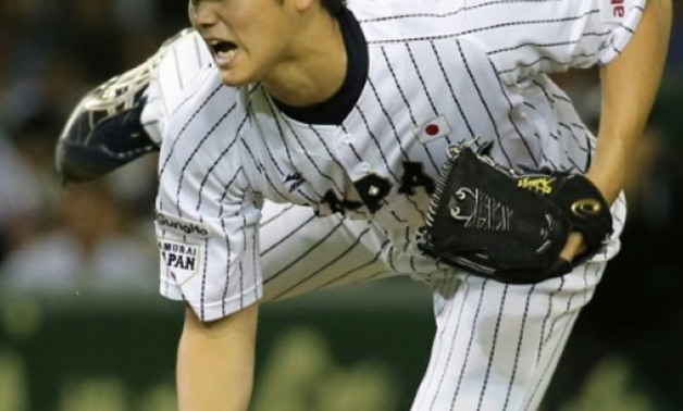 JIJI PRESS/AFP/File | Nippon Ham Fighters pitcher Shohei Otani, pictured in 2015, will have the opportunity to play Stateside between November and March when his team makes him available for bids from Major League Baseball teams