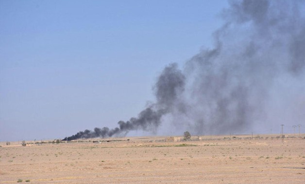 Smoke rises in Deir al Zor in this handout picture provided by SANA - REUTERS