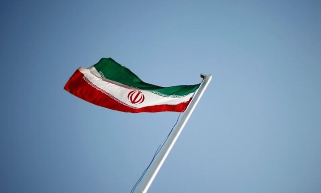 An Iranian national flag flutters in Tehran April 15 - Reuters