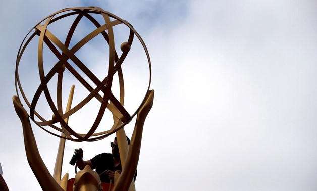 A worker touches up an Emmy statue during preparations for the 69th Emmy Awards at Microsoft Theater in Los Angeles, California, U.S., September 12, 2017. REUTERS/Mario Anzuoni